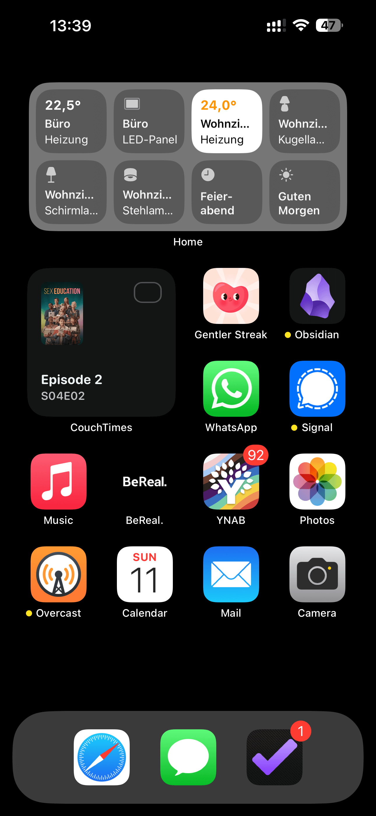 An iOS home screen with a black background and a medium Home.app widget at the top, showing 8 devices or scenes. Then there's a small CouchTimes widget showing the next unwatched episode of Sex Education. After that comes three rows of apps: Gentler Streak, Obsidian, WhatsApp, Signal, Music, BeReal, YNAB, Photos, Overcast, Calendar, Mail and Camera. The Dock has three apps: Safari, Messages and OmniFocus.